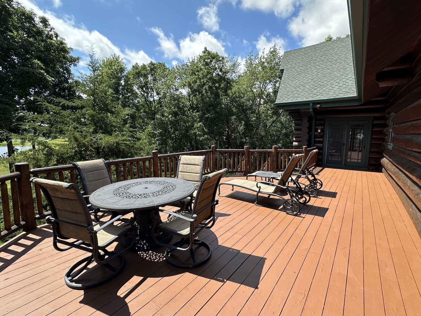 3317 South Country Club Road Woodstock, IL 60098 - Photo 31 of 43 a view of a patio with table and chairs with wooden floor and fence