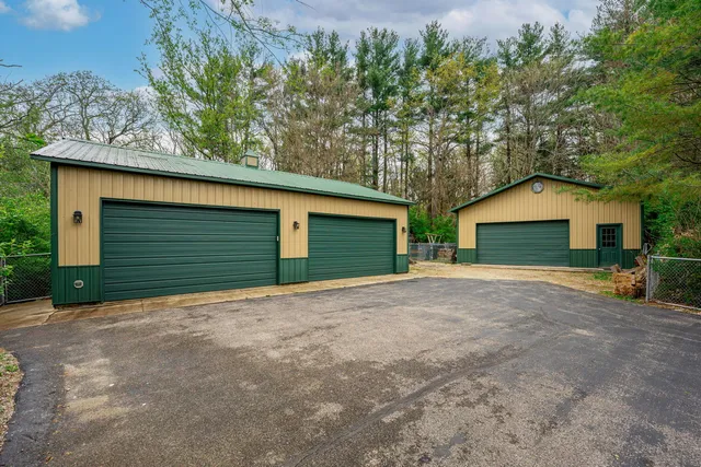 a view of a house with a balcony and parking space