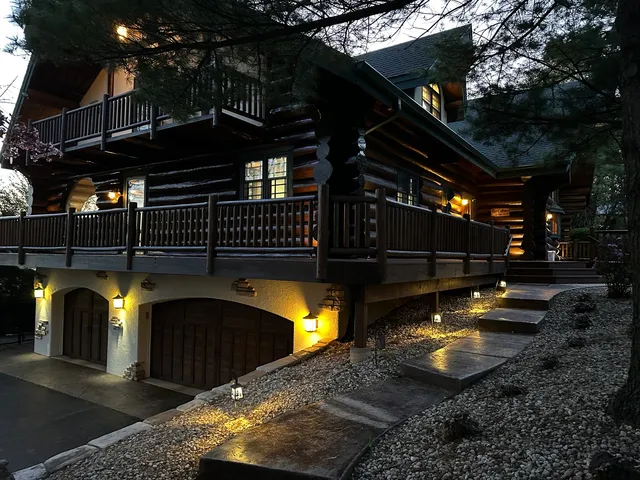 a view of a house with a small deck and furniture