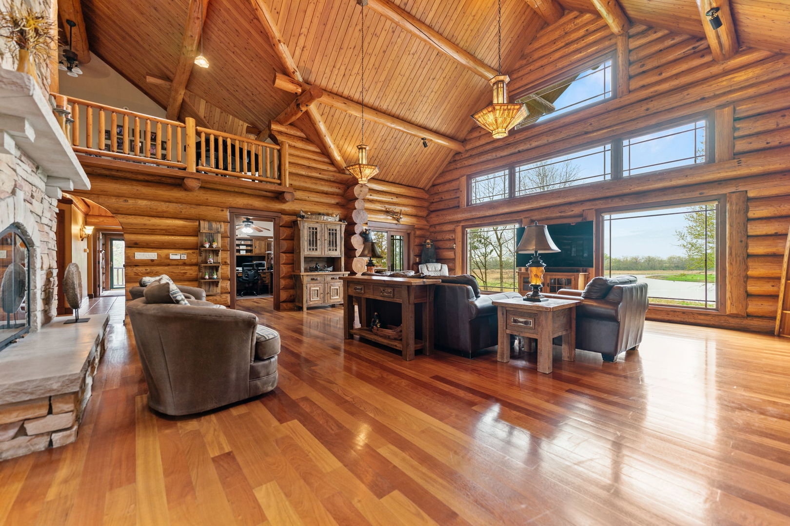 3317 South Country Club Road Woodstock, IL 60098 - Photo 6 of 43 a living room with furniture a fireplace and a floor to ceiling window