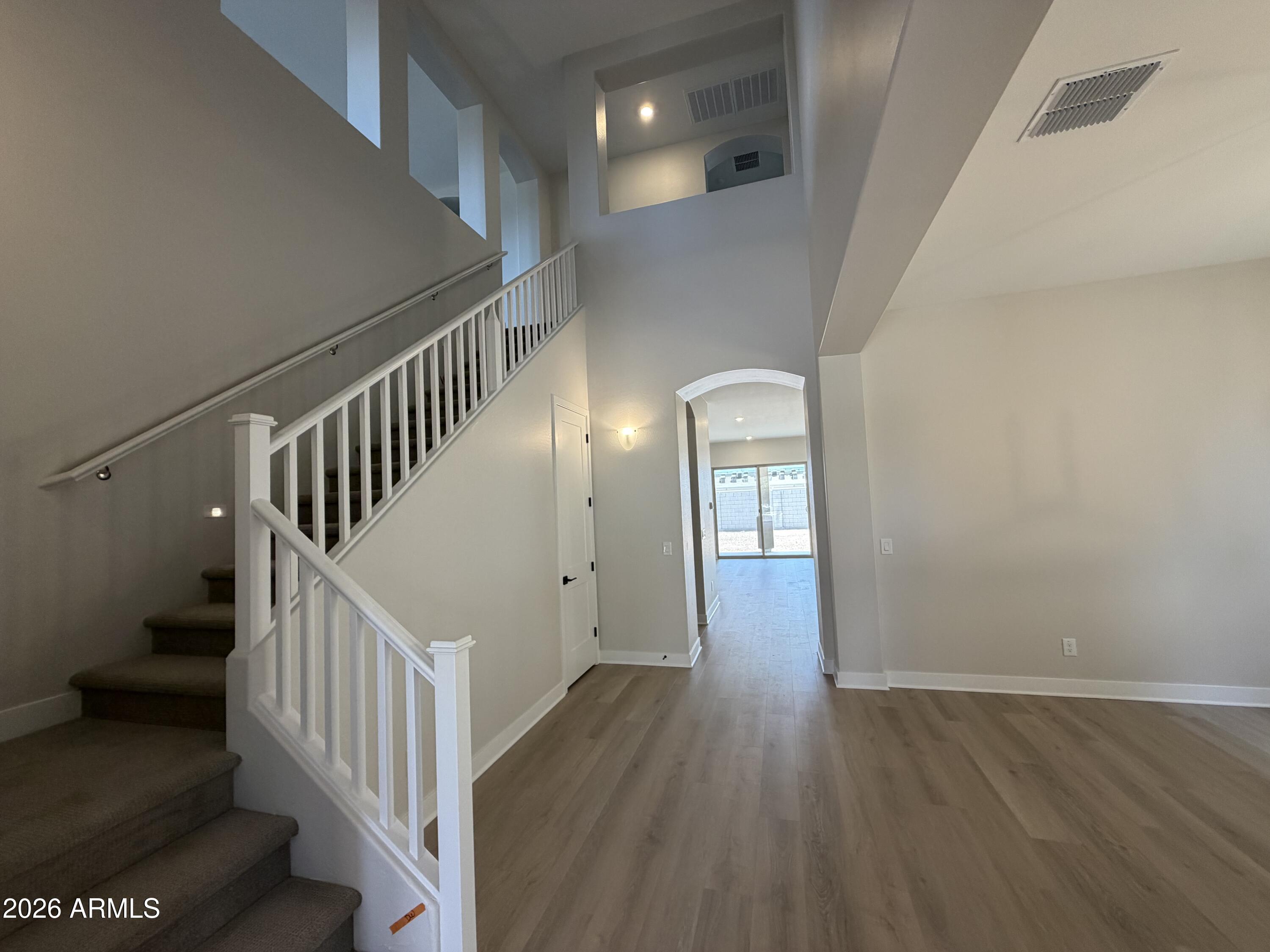 15767 West Sand Hills Road Surprise, AZ 85387 - Photo 3 of 60 a view of staircase with wooden floor and white walls