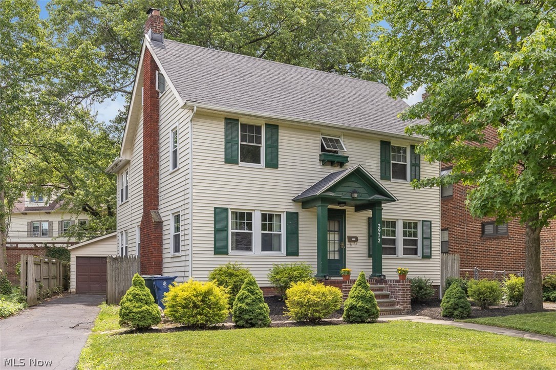 2972 Yorkshire Road Cleveland Heights, OH 44118 - Photo 2 of 44 Traditional two-story residence featuring light-colored siding, a dark-pitched roof, and a prominent brick chimney