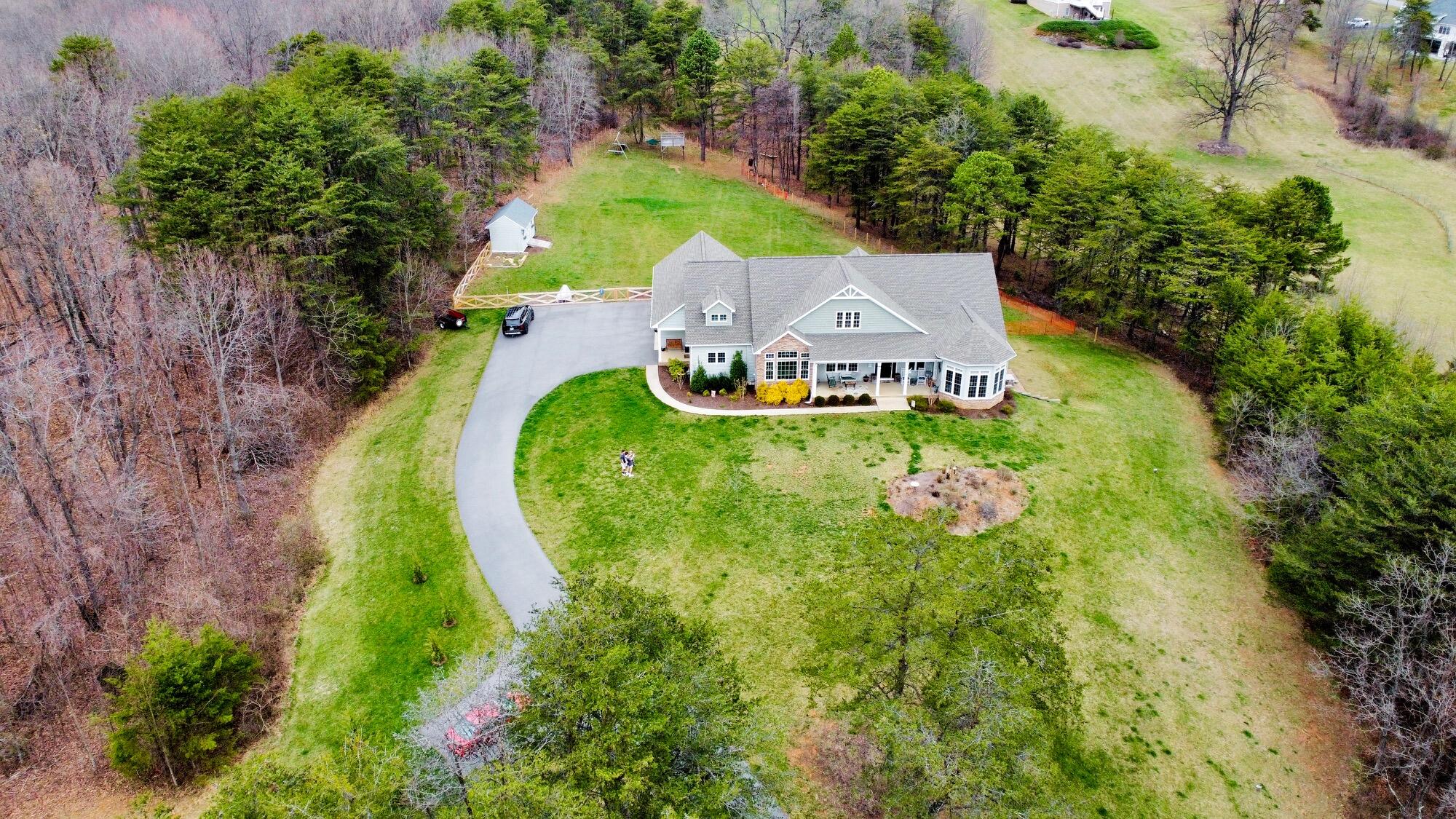 64 Hickory Ridge Court Blue Ridge, VA 24064 - Photo 2 of 61 an aerial view of a house with a garden and swimming pool