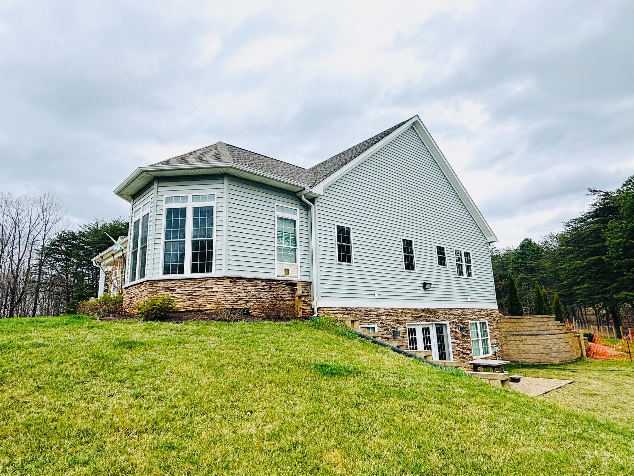 64 Hickory Ridge Court Blue Ridge, VA 24064 - Photo 5 of 61 a front view of a house with a yard and trees