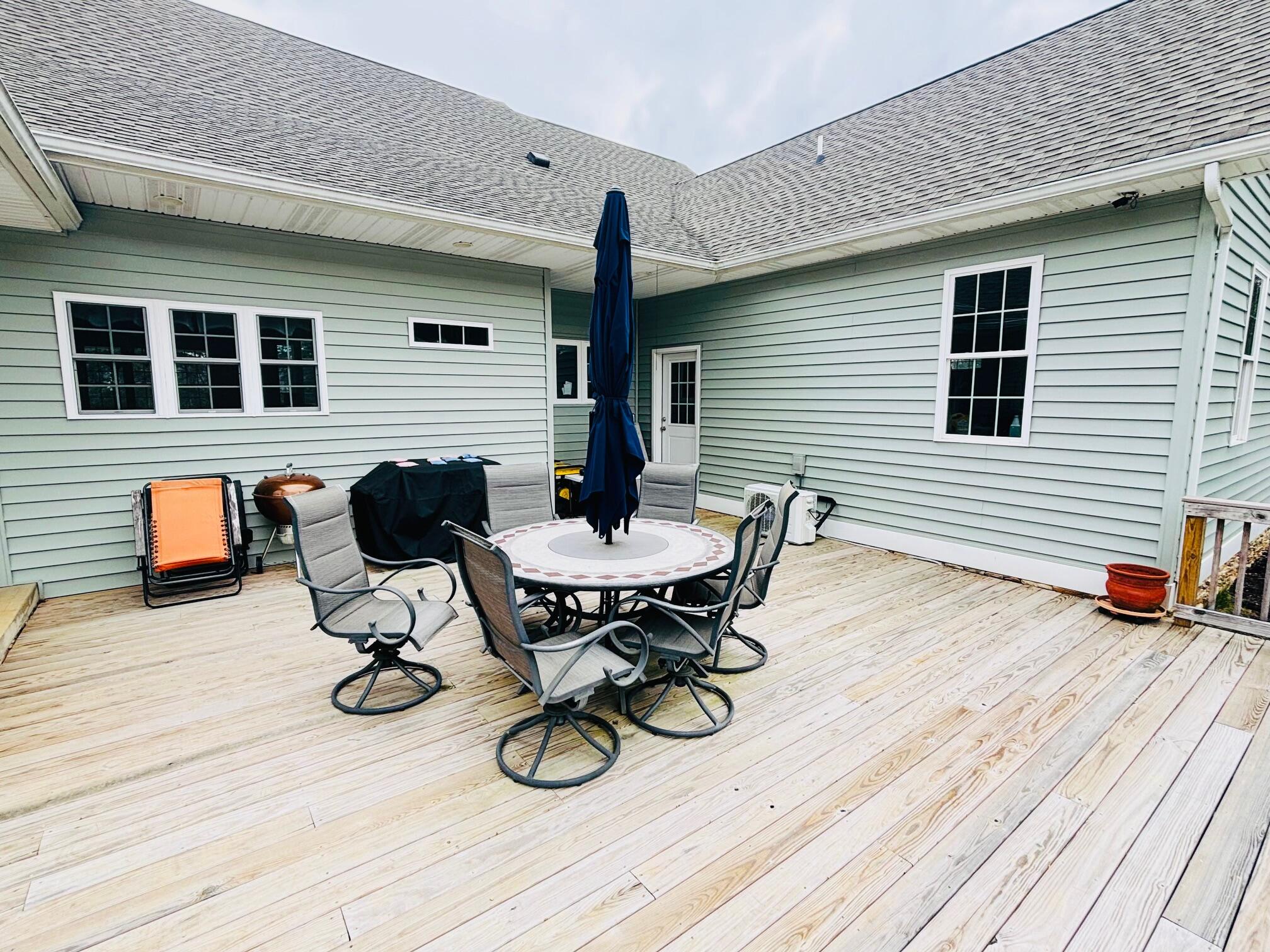 64 Hickory Ridge Court Blue Ridge, VA 24064 - Photo 60 of 61 a view of a deck with table and chairs with wooden floor