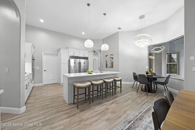 a view of a dining room with furniture and wooden floor