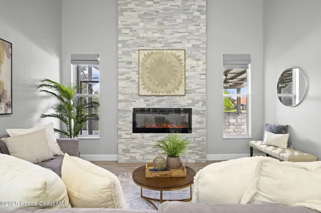 a living room with furniture potted plant and a fireplace