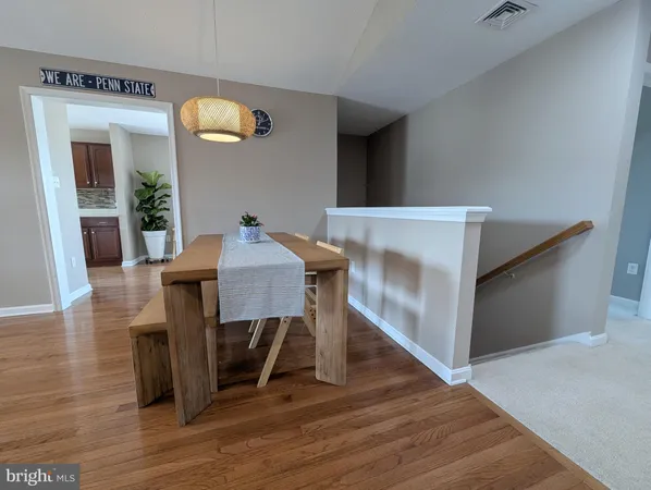 a kitchen with sink a refrigerator and wooden floor