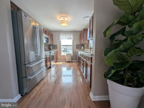 a kitchen with granite countertop wood cabinets and a stove top oven