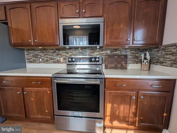 a kitchen with stainless steel appliances a stove a sink and a microwave