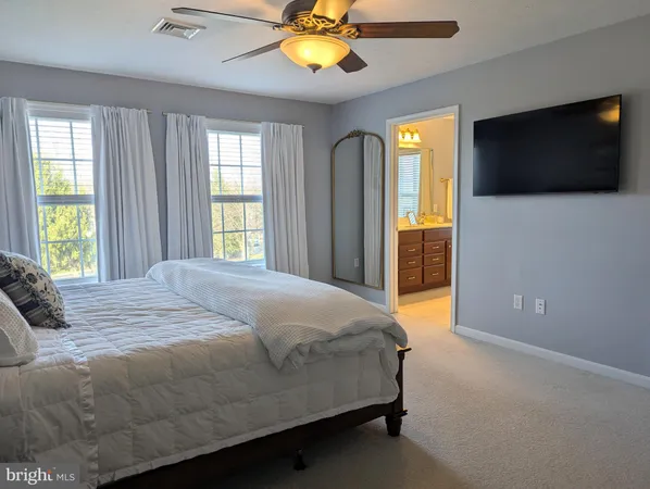 a view of walk in closet with clothes