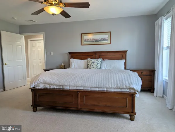 a spacious bathroom with a double vanity sink a mirror and a bathtub