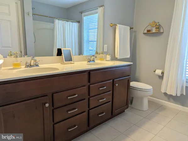 a spacious bedroom with a bed and a chandelier