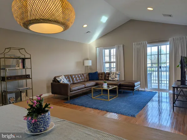 a living room with furniture windows and wooden floor