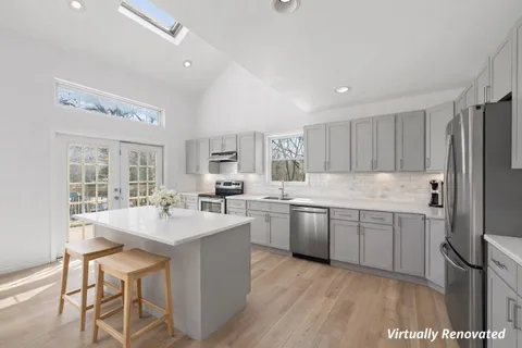 a kitchen with a sink refrigerator and cabinets