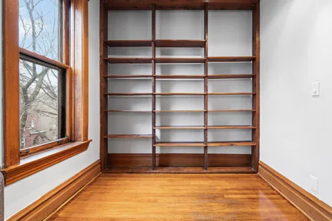a view of a room with shelves on the wall