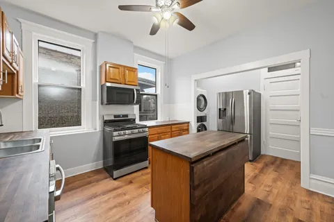 a kitchen with stainless steel appliances granite countertop a stove and a refrigerator