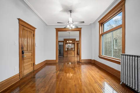 a view of a room with wooden floor staircase and windows