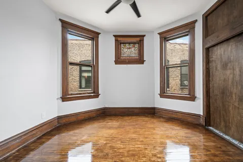 a view of an empty room with window and closet area