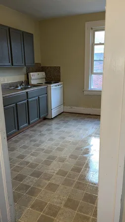 a view of a kitchen with wooden floor and electronic appliances