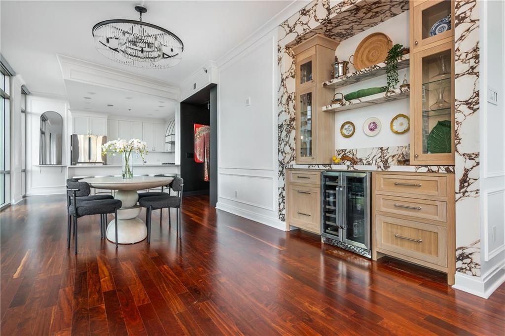 905 Juniper Street Northeast, Unit 705 Atlanta, GA 30309 - Photo 11 of 62 a view of a dining room with furniture and wooden floor