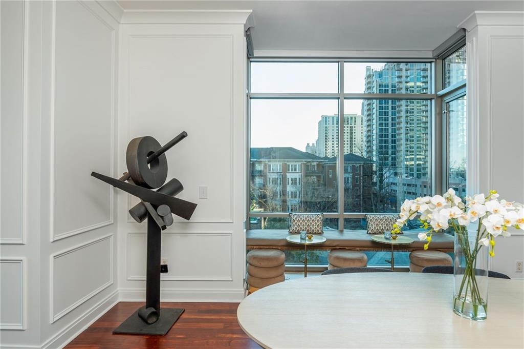905 Juniper Street Northeast, Unit 705 Atlanta, GA 30309 - Photo 18 of 62 a living room filled with furniture and a floor to ceiling window