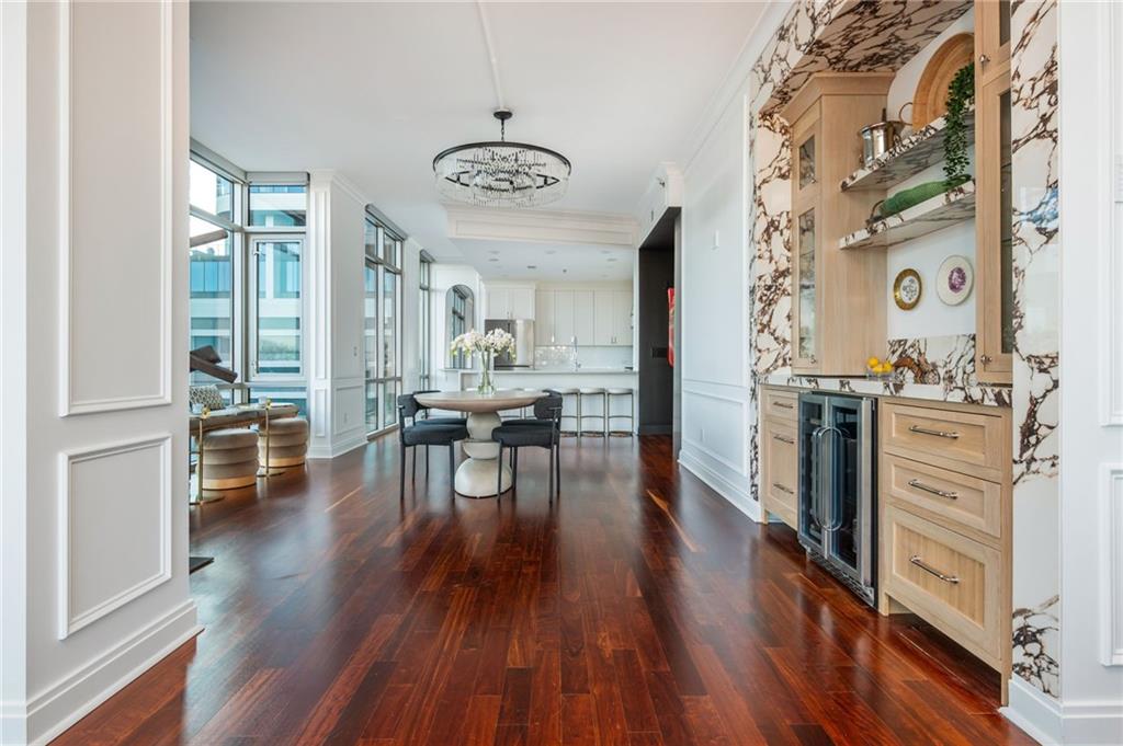 905 Juniper Street Northeast, Unit 705 Atlanta, GA 30309 - Photo 19 of 62 a view of a dining room with furniture and wooden floor