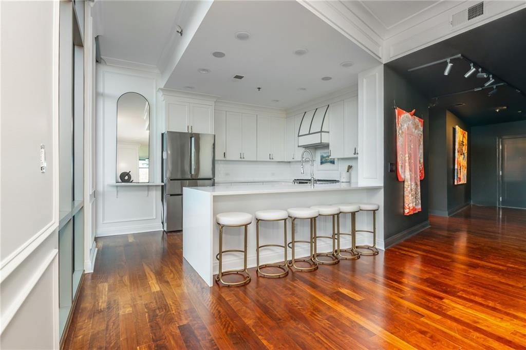 905 Juniper Street Northeast, Unit 705 Atlanta, GA 30309 - Photo 2 of 62 a view of kitchen with cabinets and wooden floor