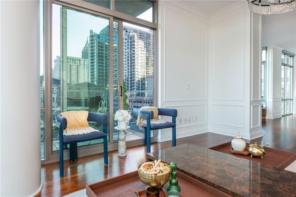 905 Juniper Street Northeast, Unit 705 Atlanta, GA 30309 - Photo 24 of 62 a living room with furniture and a wooden floor