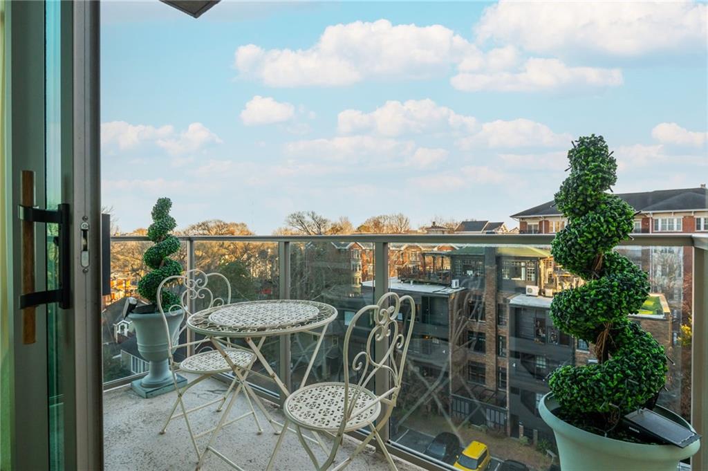 905 Juniper Street Northeast, Unit 705 Atlanta, GA 30309 - Photo 25 of 62 a view of a chairs and table on the terrace