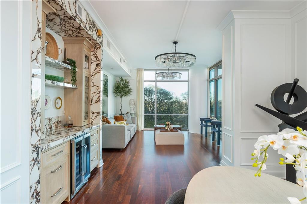905 Juniper Street Northeast, Unit 705 Atlanta, GA 30309 - Photo 27 of 62 a living room with furniture and wooden floor