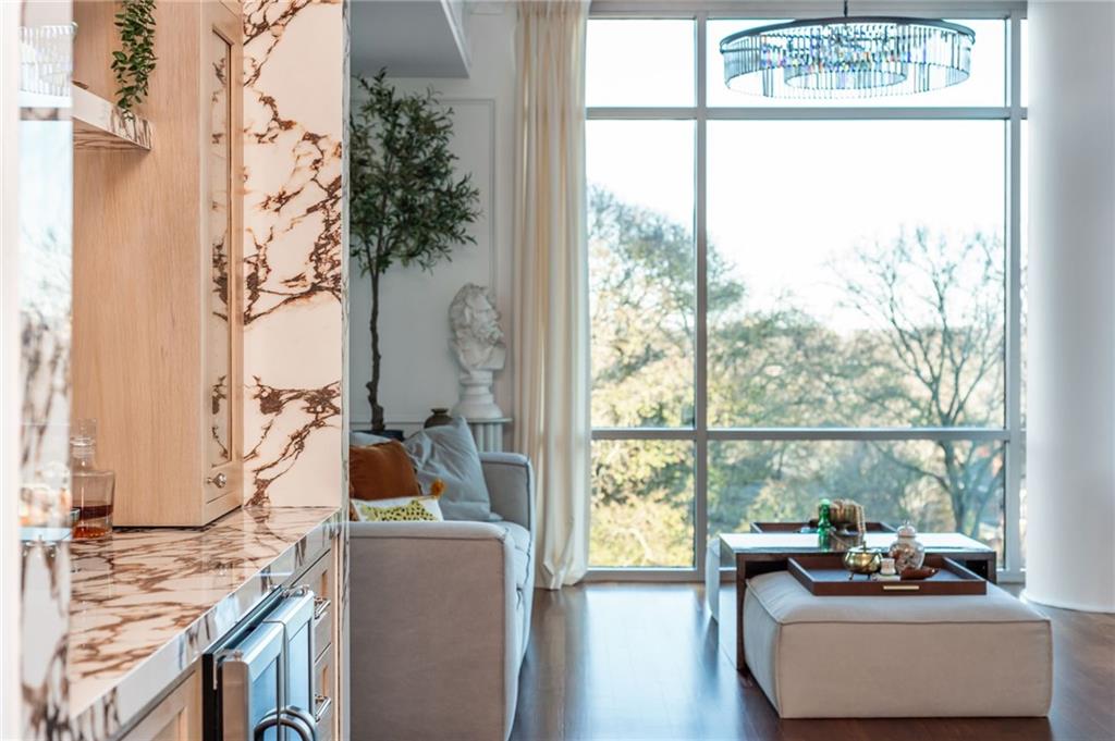 905 Juniper Street Northeast, Unit 705 Atlanta, GA 30309 - Photo 32 of 62 a living room with furniture and a window