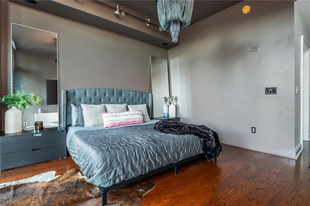 905 Juniper Street Northeast, Unit 705 Atlanta, GA 30309 - Photo 38 of 62 a bedroom with a bed and a potted plant