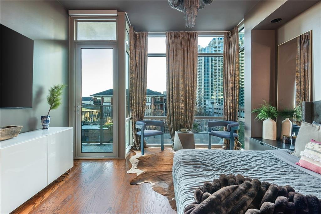 905 Juniper Street Northeast, Unit 705 Atlanta, GA 30309 - Photo 39 of 62 a bedroom with a bed and large windows