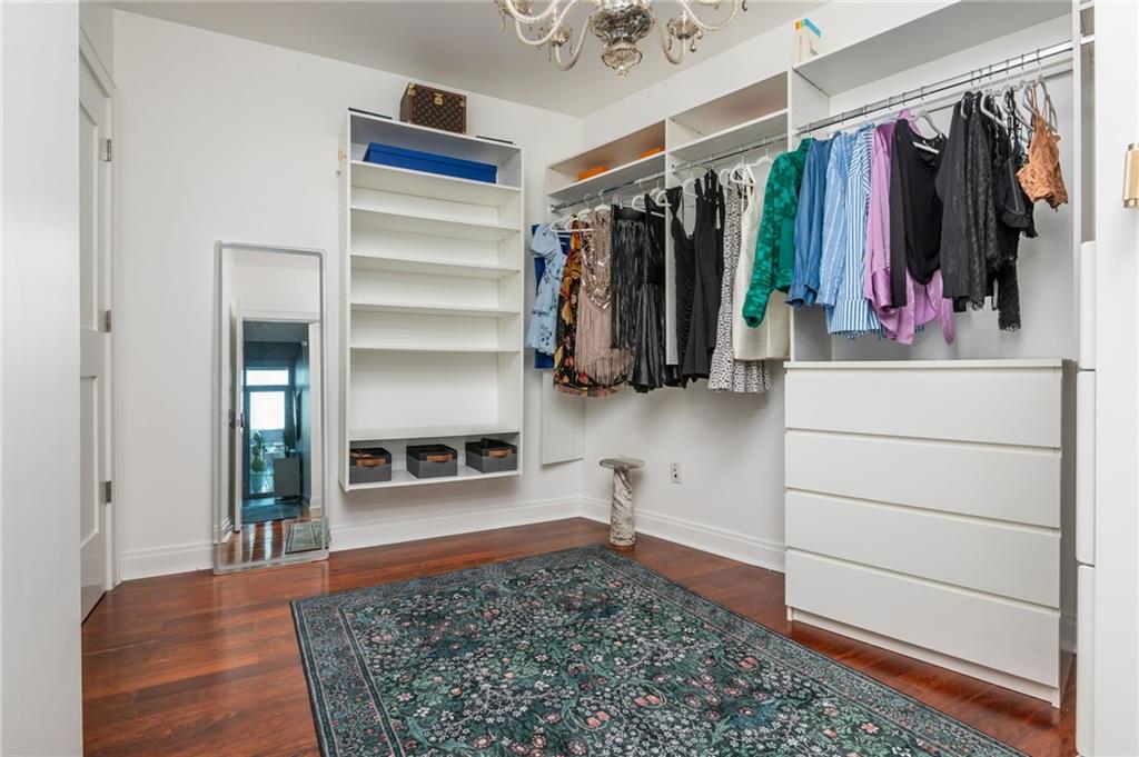 905 Juniper Street Northeast, Unit 705 Atlanta, GA 30309 - Photo 41 of 62 a view of walk in closet with clothes and shoes