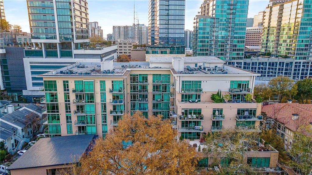 905 Juniper Street Northeast, Unit 705 Atlanta, GA 30309 - Photo 59 of 62 a front view of a house with a garden and outdoor seating