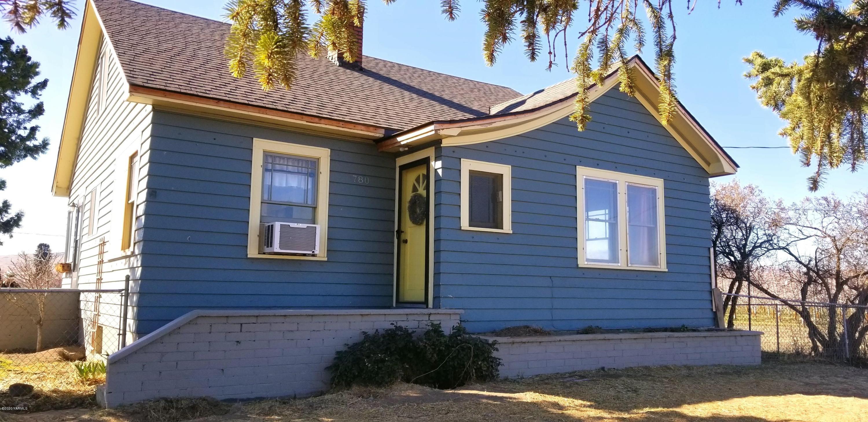 a view of a brick house with a yard