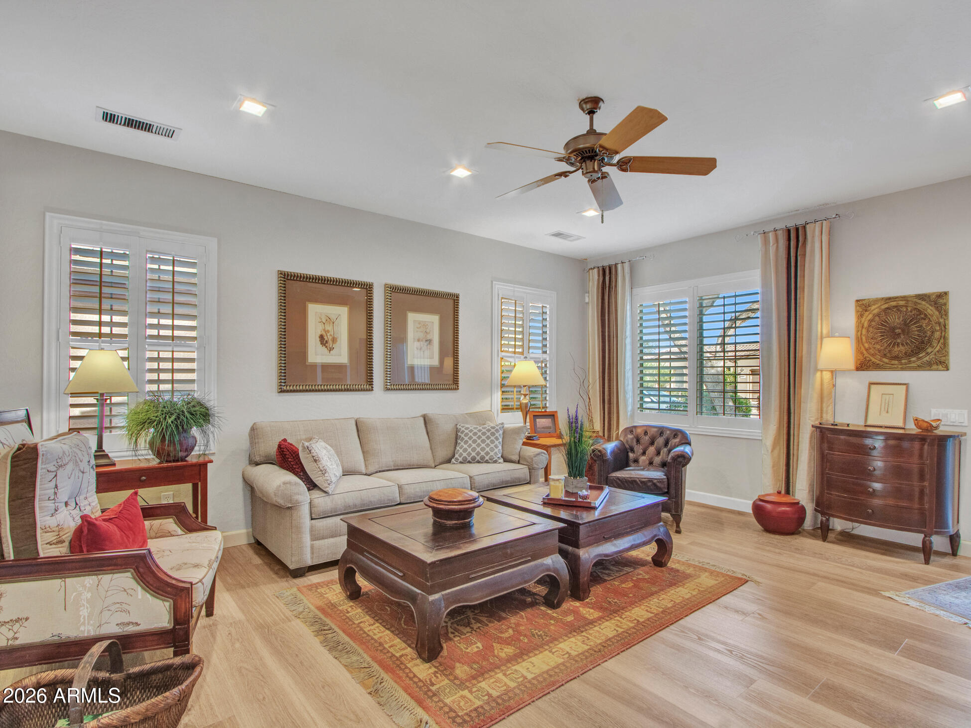 19760 North Los Altos Way Surprise, AZ 85374 - Photo 31 of 53 a living room with furniture a flat screen tv and a window