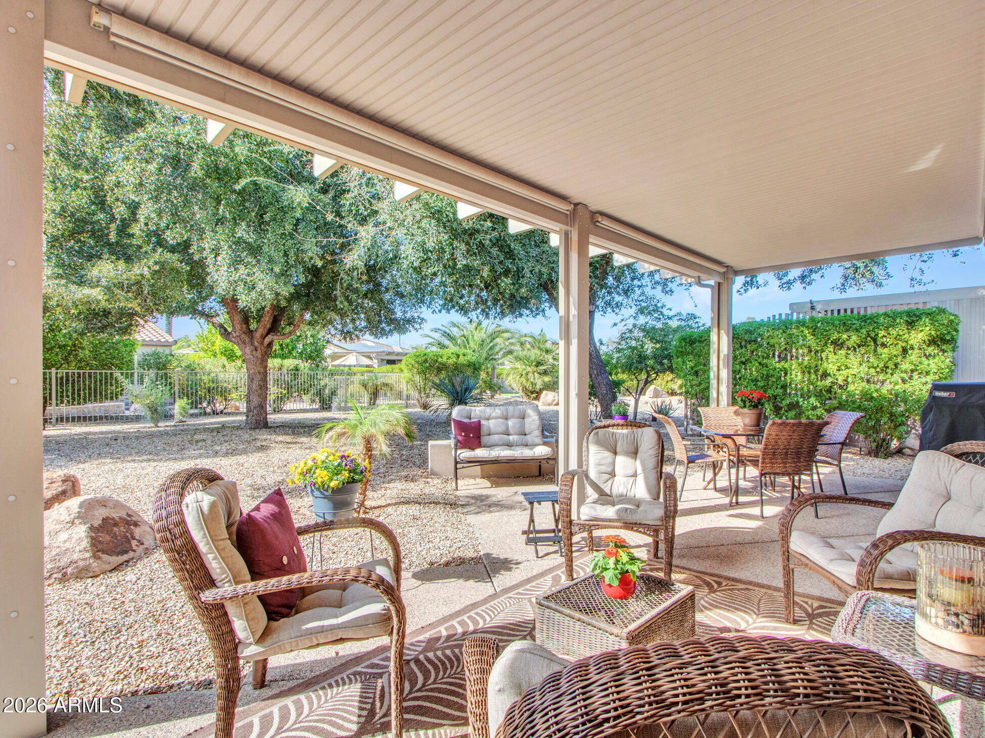 19760 North Los Altos Way Surprise, AZ 85374 - Photo 38 of 53 a living room with patio furniture and a floor to ceiling window
