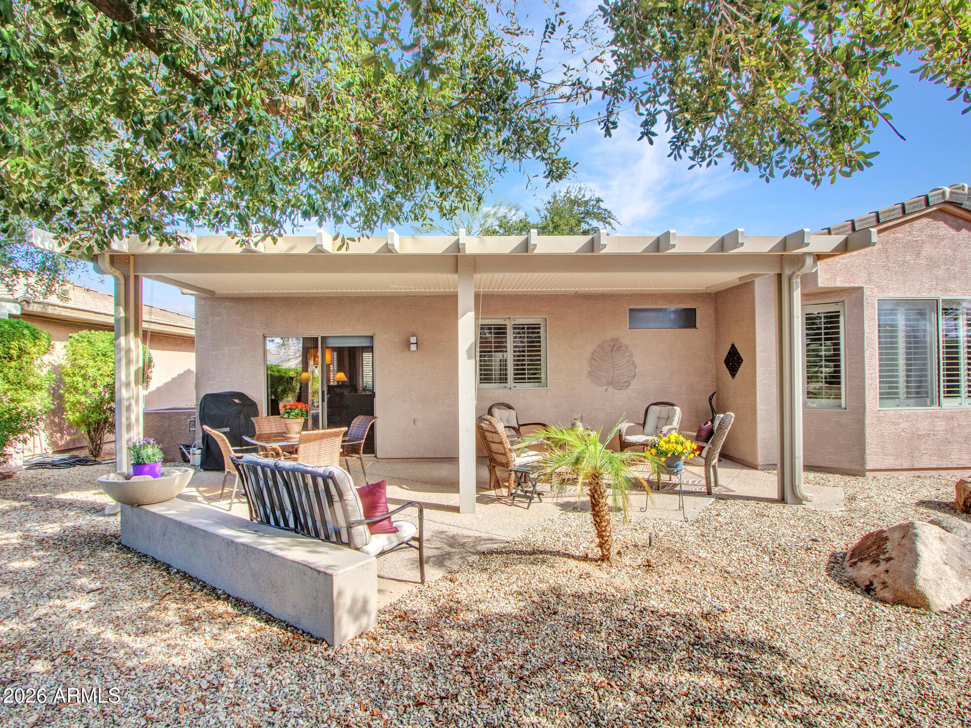 19760 North Los Altos Way Surprise, AZ 85374 - Photo 39 of 53 a view of a patio with a dining table and chairs with wooden fence