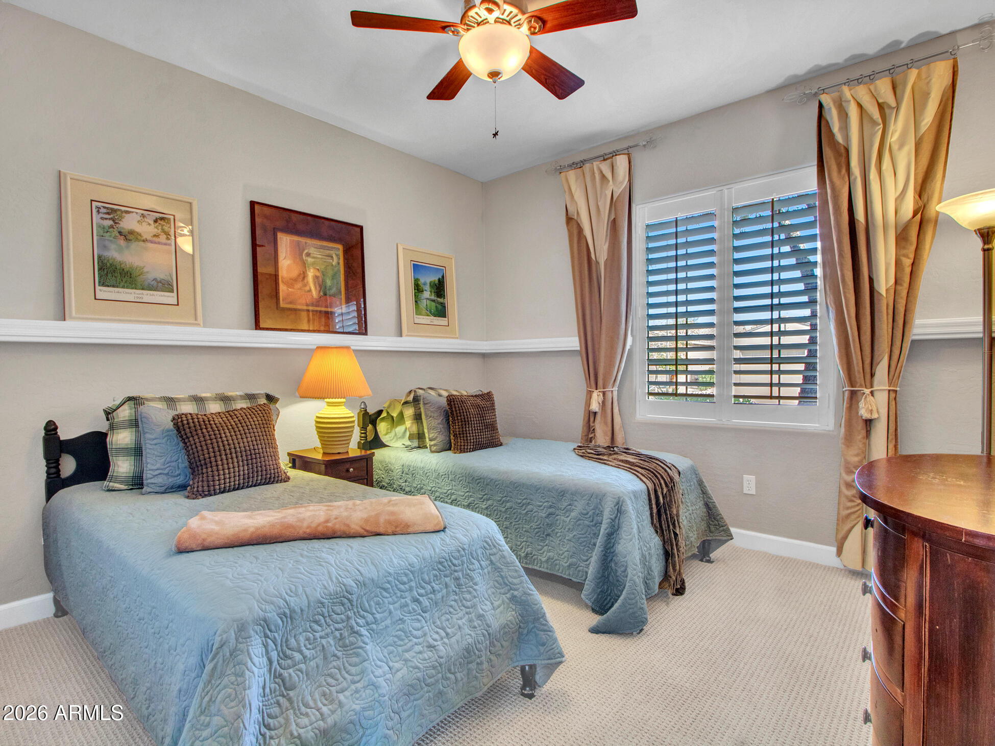 19760 North Los Altos Way Surprise, AZ 85374 - Photo 41 of 53 a bed room with two beds and a chandelier