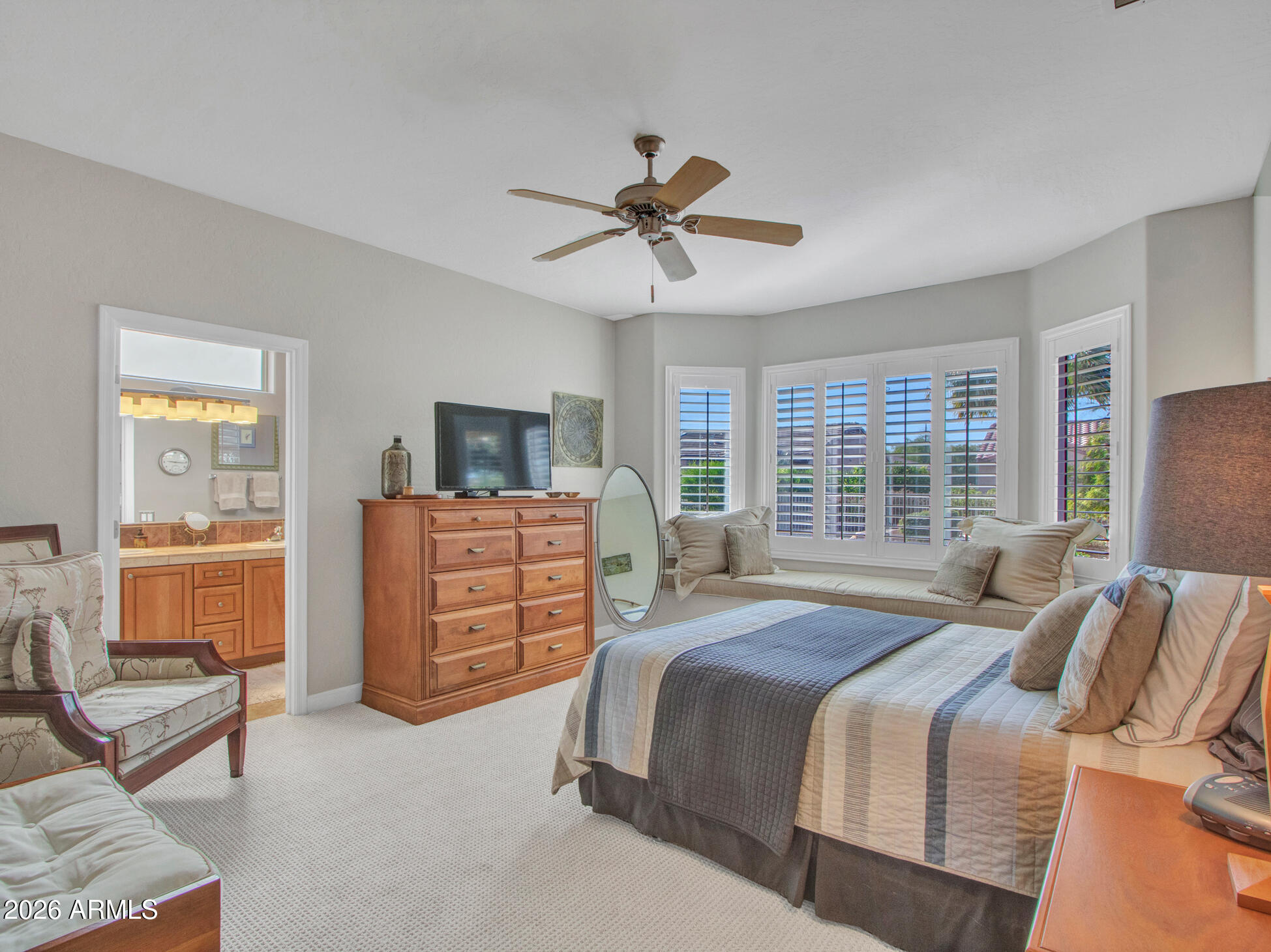 19760 North Los Altos Way Surprise, AZ 85374 - Photo 46 of 53 a bedroom with a bed a dresser and a chandelier