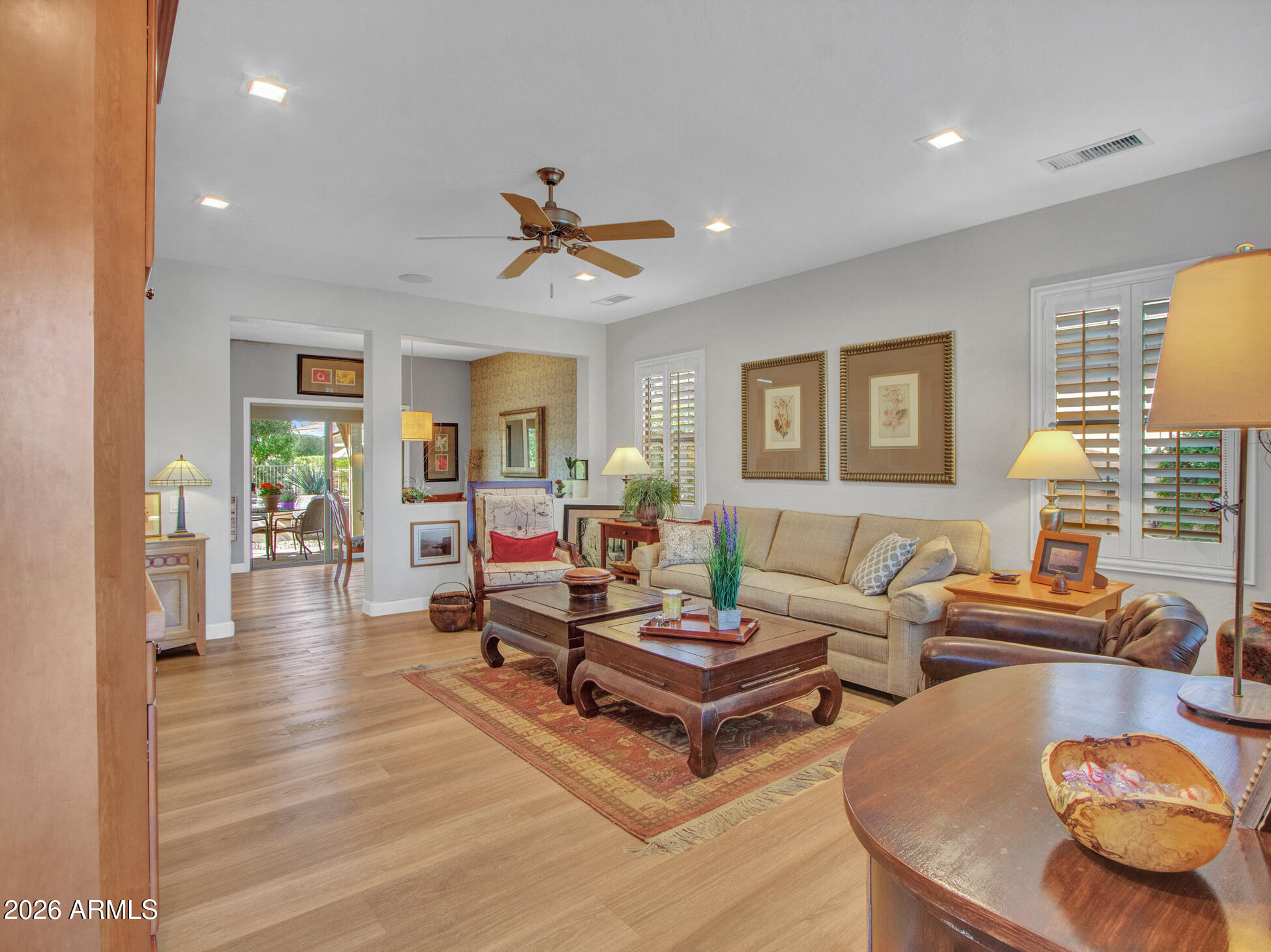 19760 North Los Altos Way Surprise, AZ 85374 - Photo 3 of 53 a living room with fireplace furniture and a wooden floor