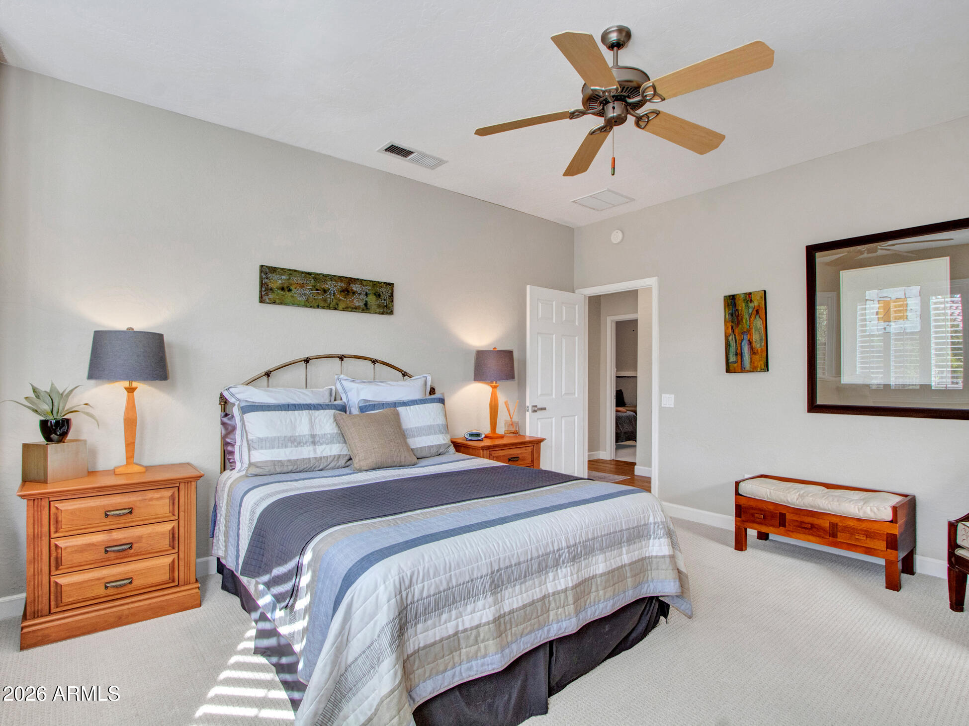 19760 North Los Altos Way Surprise, AZ 85374 - Photo 47 of 53 a bedroom with a bed and a chandelier