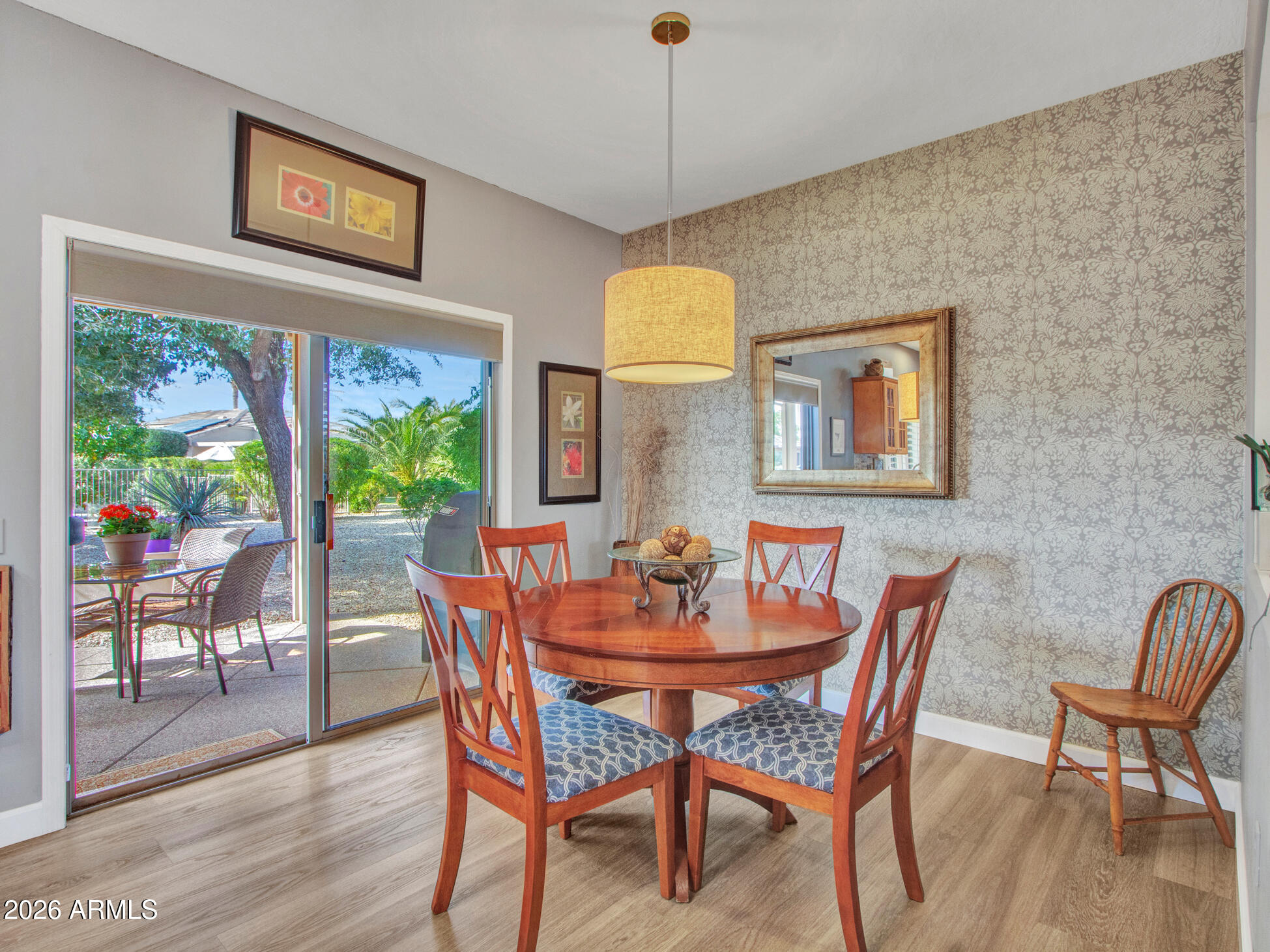 19760 North Los Altos Way Surprise, AZ 85374 - Photo 5 of 53 a view of a dining room with furniture a chandelier and wooden floor