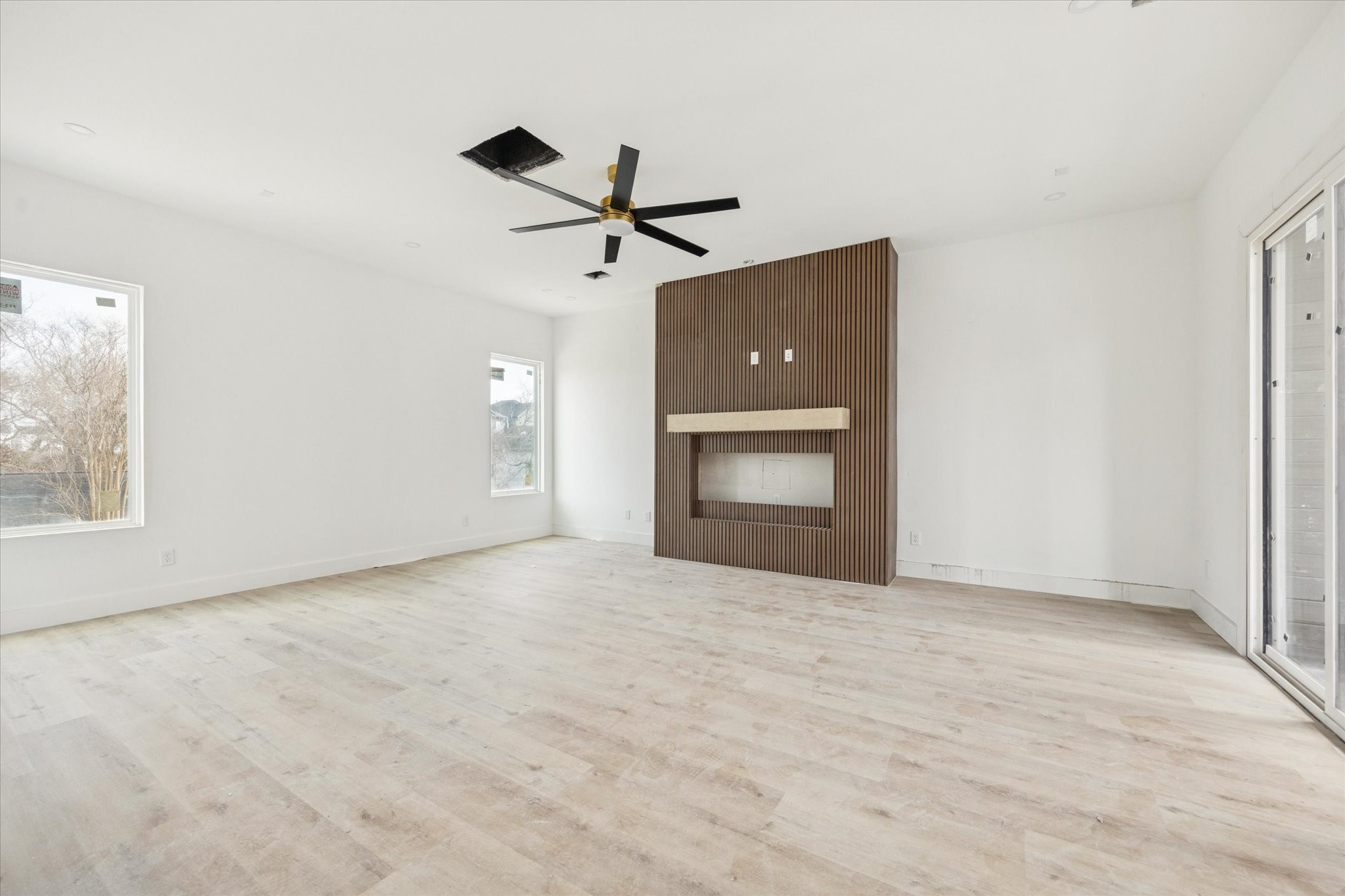 1032 West 17th Street, Unit A Houston, TX 77008 - Photo 9 of 21 a view of an empty room with a fireplace and a window