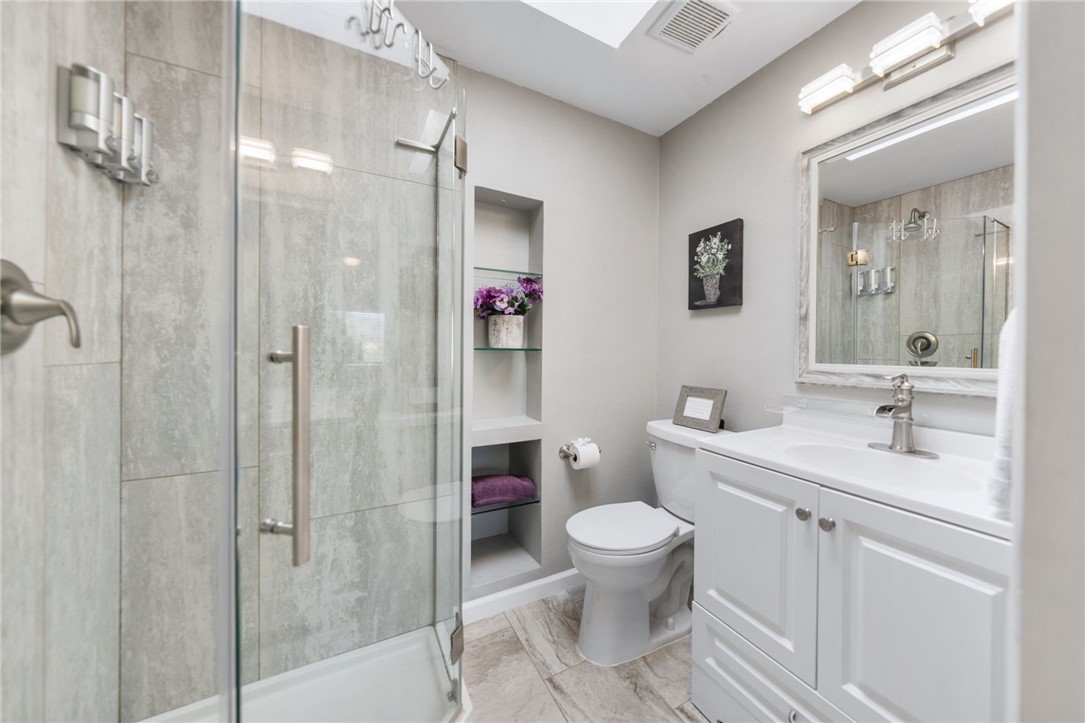 35825 Meadow Ridge Road Temecula, CA 92592 - Photo 46 of 75 a bathroom with a toilet sink vanity granite and shower
