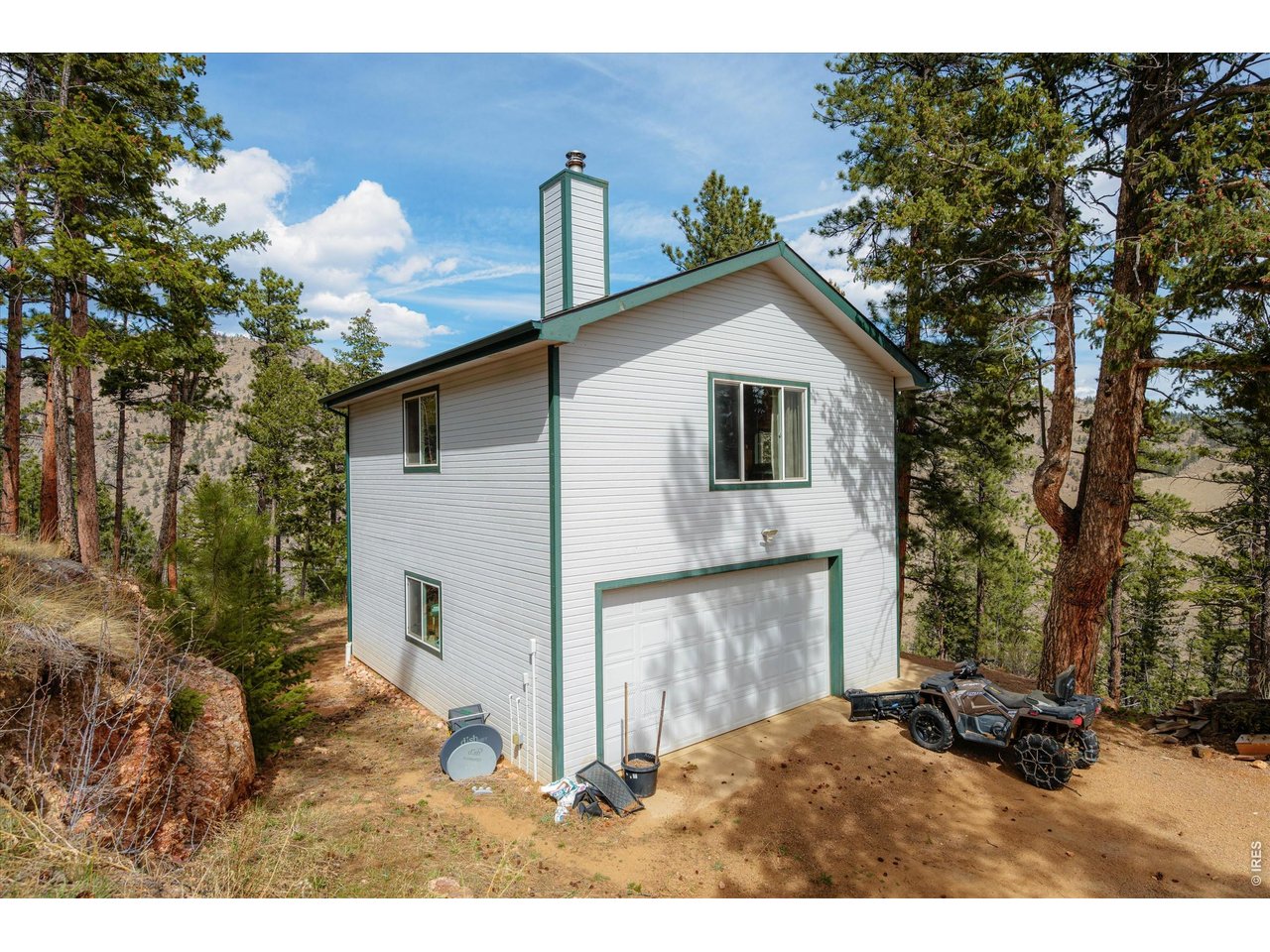 842 Unger Mountain Road Bellvue, CO 80512 - Photo 23 of 45 a backyard of a house with table and chairs