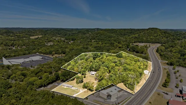 an aerial view of a residential houses with city view