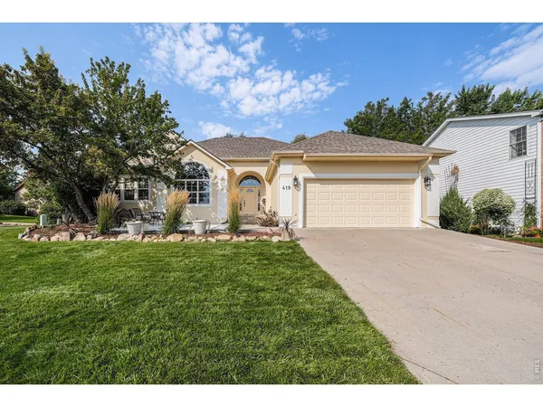 a front view of a house with a yard and garage
